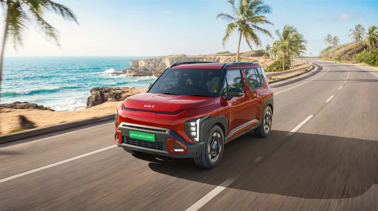 Kia Syros EV driving on a coastal road
