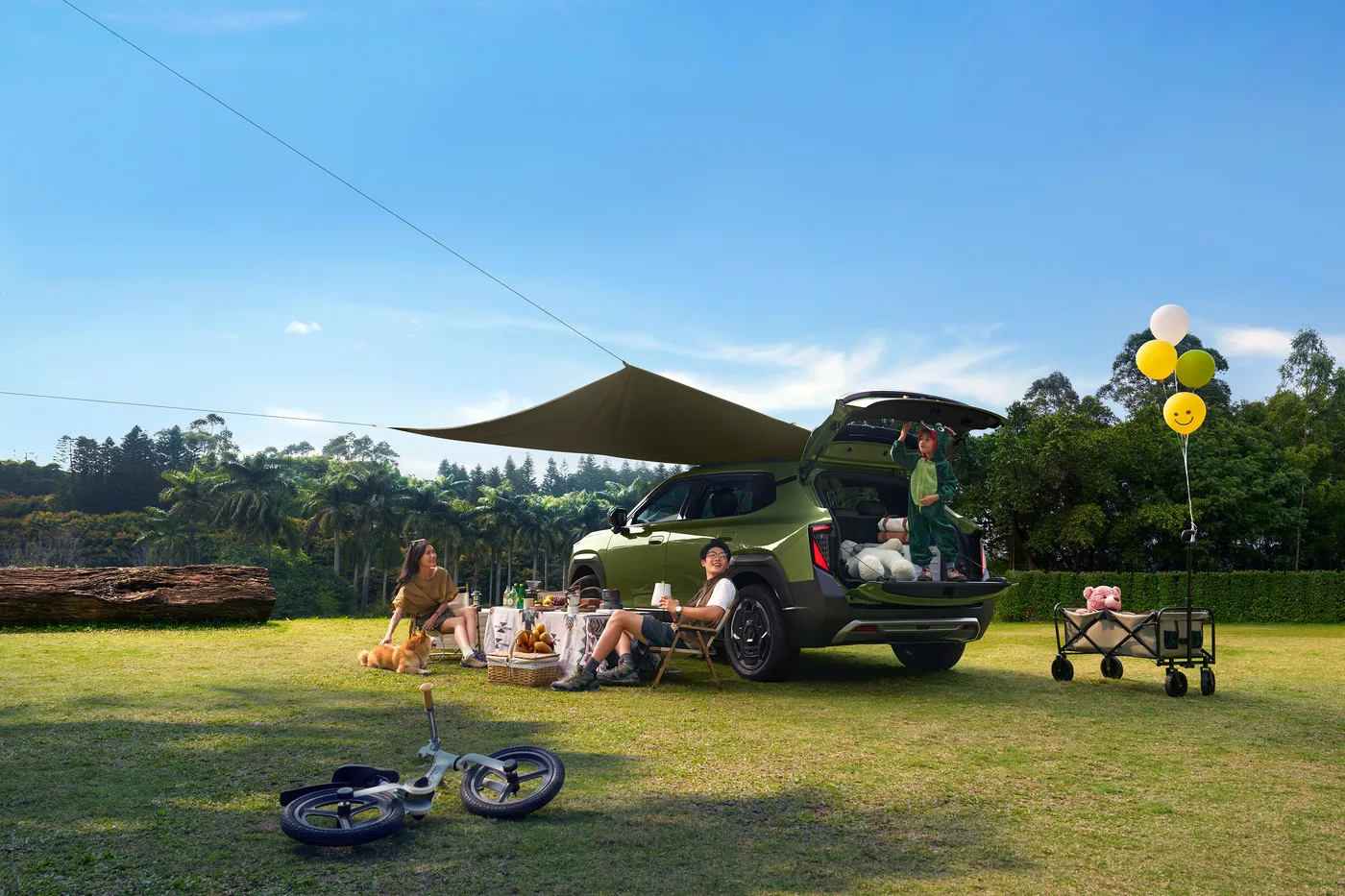 Dongfeng Nammi Vigo parked on grass with tailgate open at a campsite