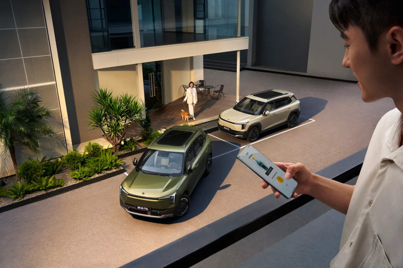 Owner using a phone app beside a parked Nammi Vigo