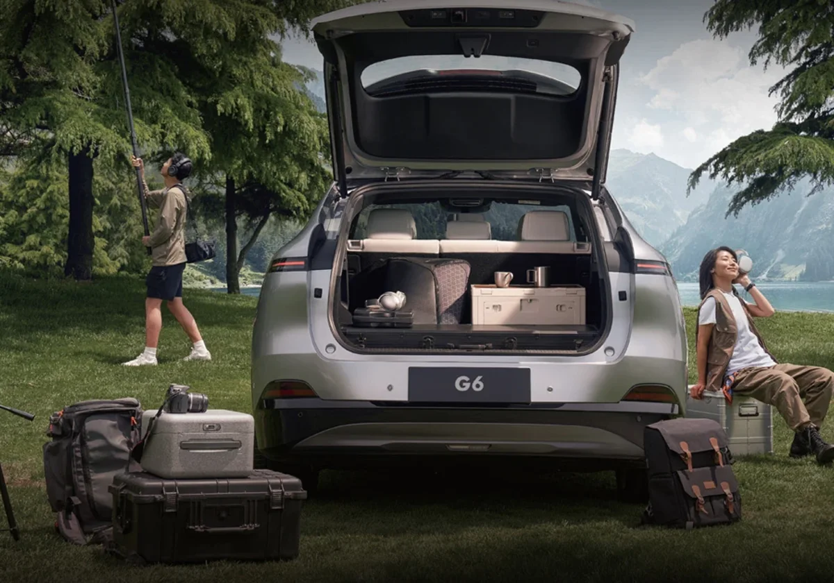 XPENG G6 with its powered tailgate open and the boot loaded with camping gear